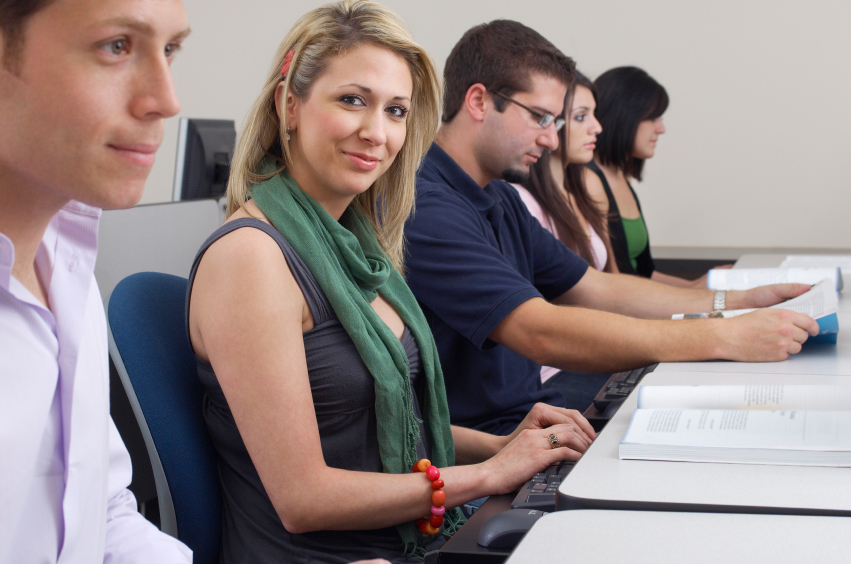 A program team working together at a row of laptops